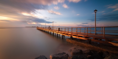 long dock and sunset overlooking the water